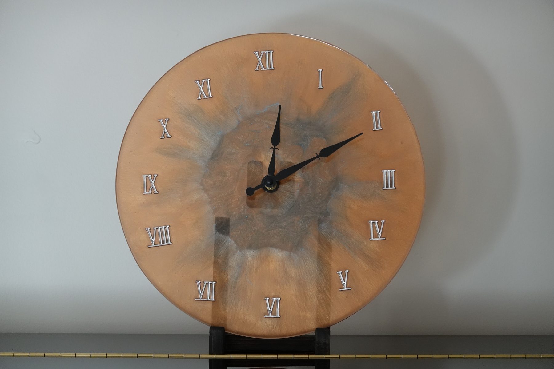 Copper Bloom clock, a copper-toned resin clock with organic marbled texture