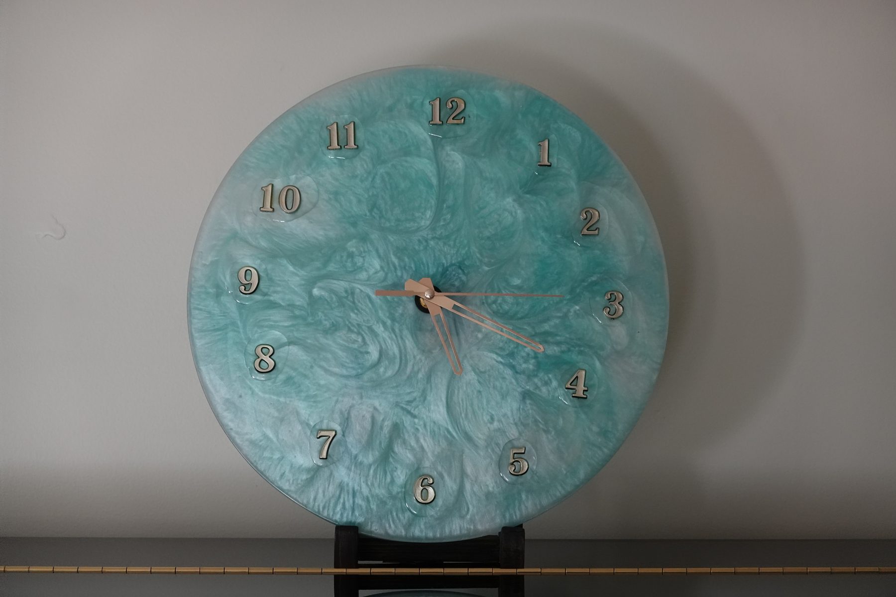 Tidewater clock, a teal marbled resin clock with rose gold hands