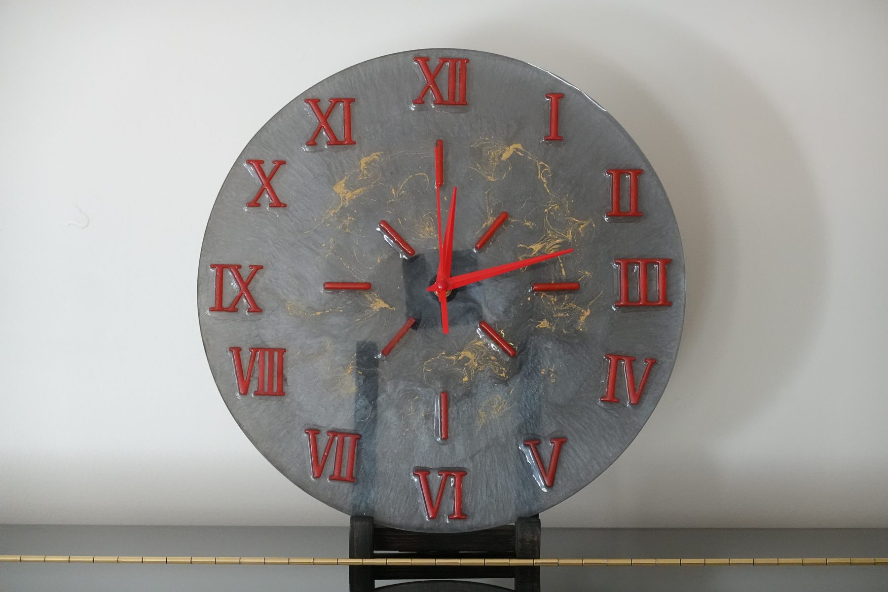 Slate & Gold clock, a gray resin clock with gold veining and red Roman numerals
